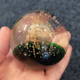 Golden Orb Over Emerald Glass Paperweight #38